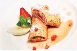 Various Belgian style crepe filled with fruit and fruit coulis